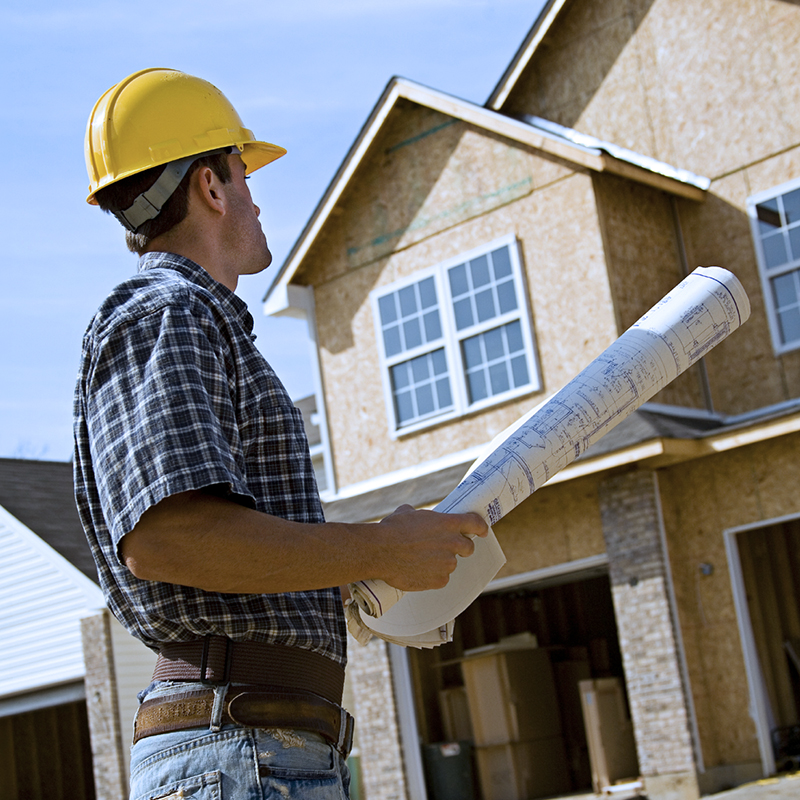 Construction worker with hard hat and blueprints